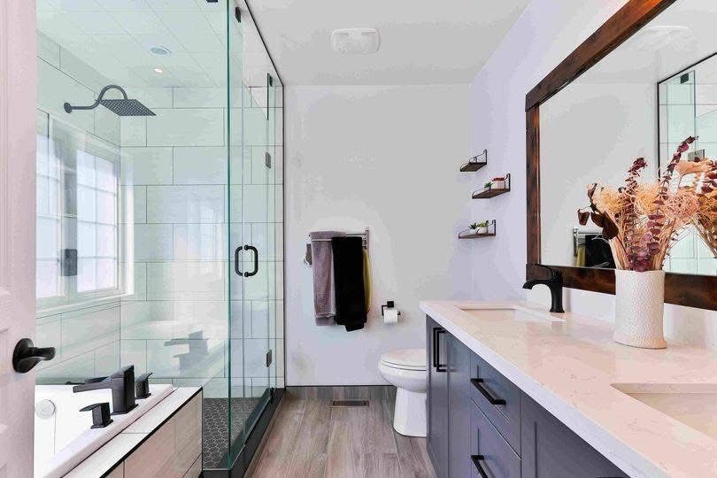 Bathroom with a glass shower, twin vanity and matte black fittings
